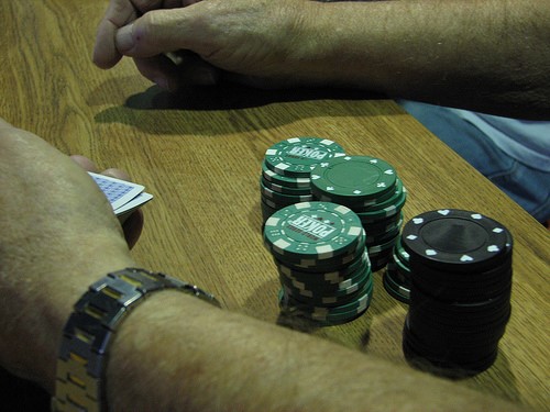 arms with poker chip stack