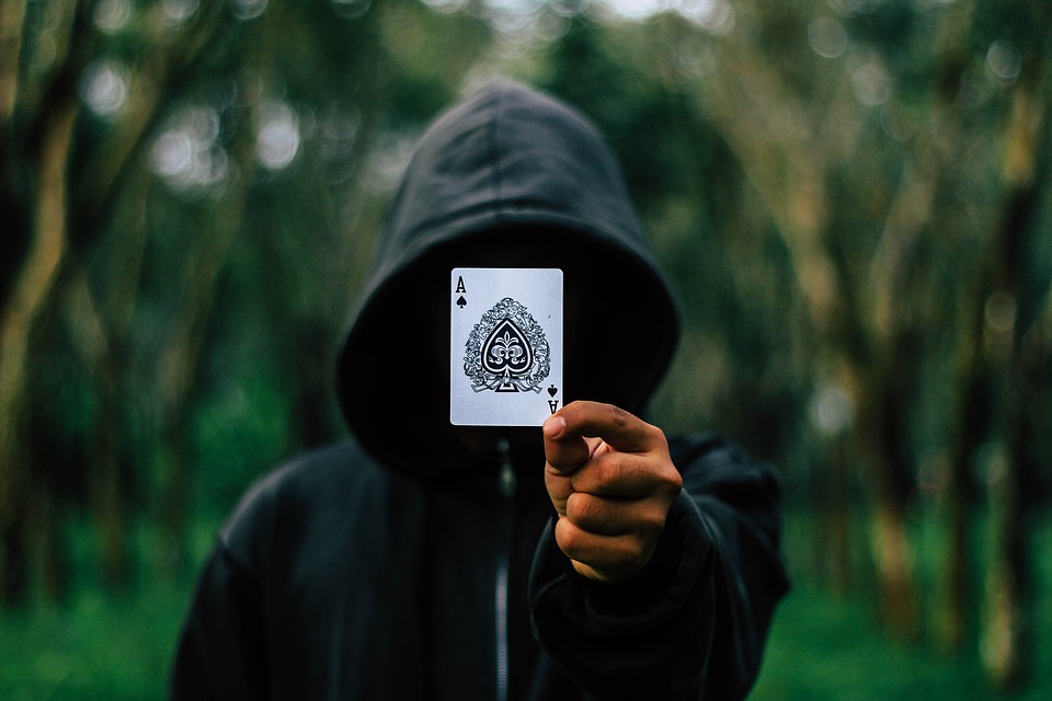 Hooded guy holding an ace