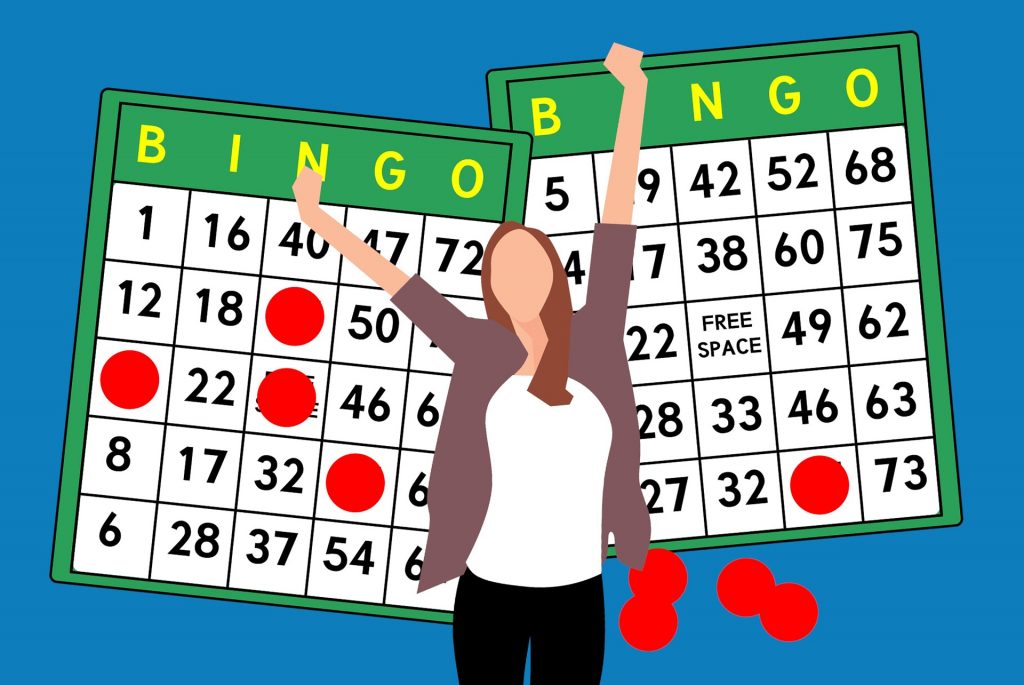 A lady exuberantly playing bingo