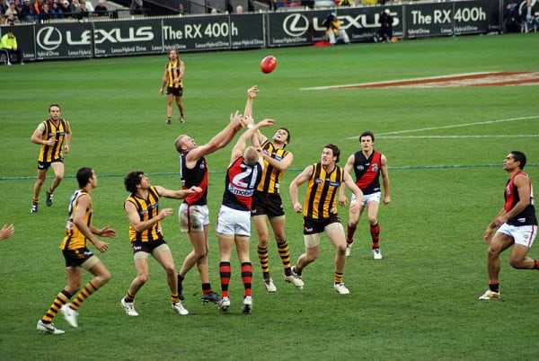 Men jumping for a ball, aussie rules football