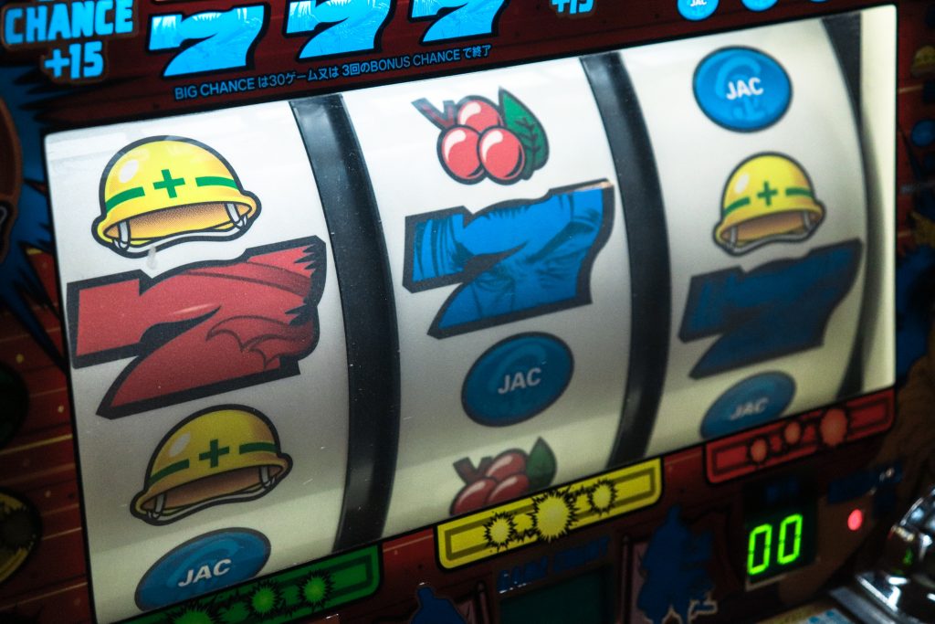 Three sevens showing on a slot machine