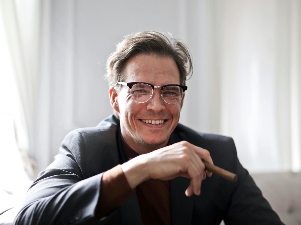 Smiling man with glasses in a suit jacket