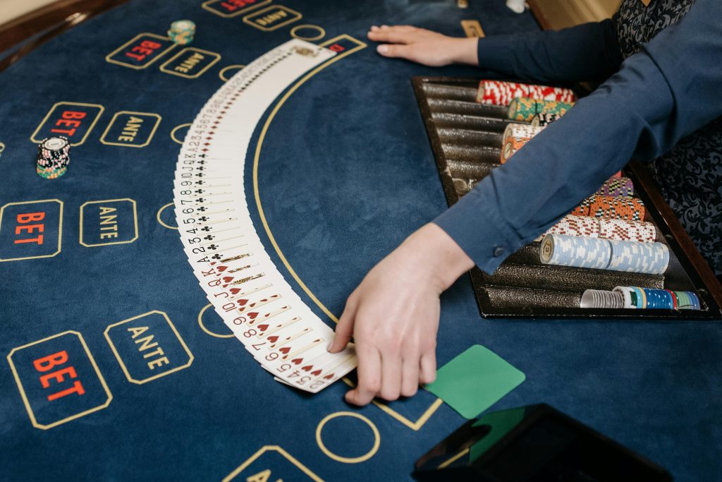 A dealer's arms and hands at a casino table