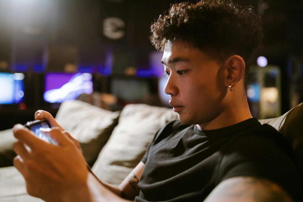 Guy sitting on couch on his phone